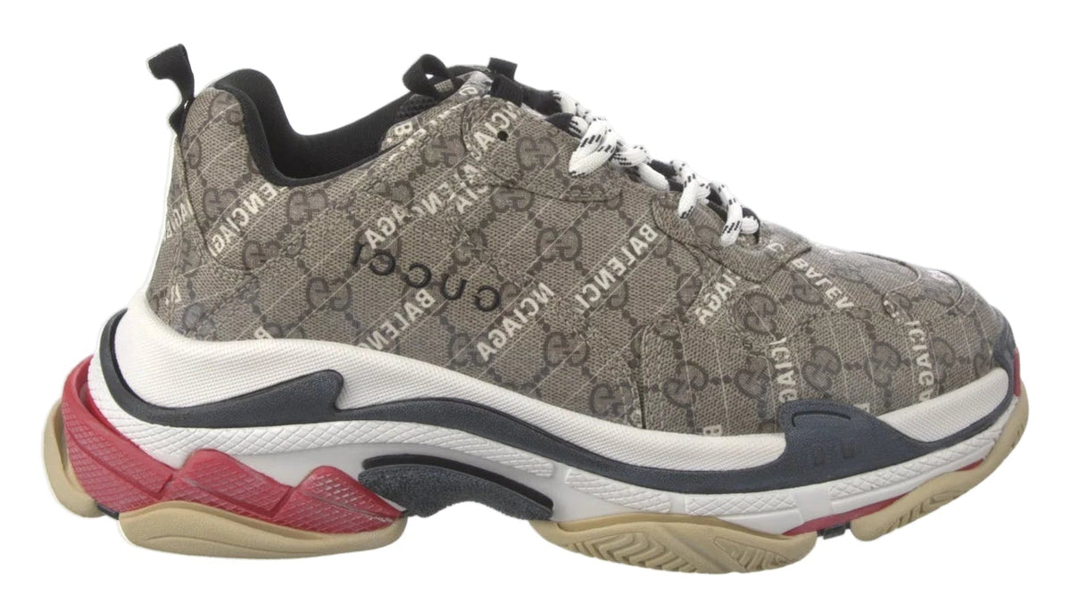Gray sneaker with red accents on a white background