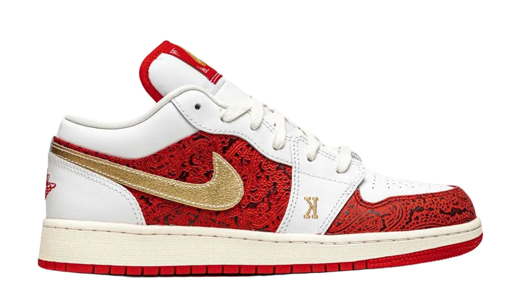 White sneaker with red and gold design on a white background