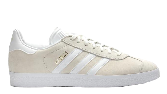 Beige sneaker with white stripes on a light gray background