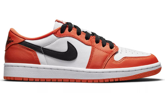 Orange and white sneaker with black accents on a white background