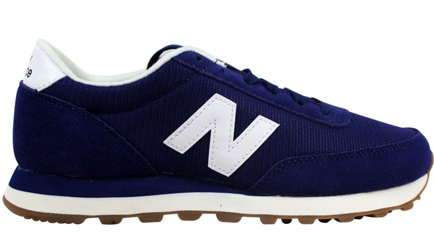 Navy blue sneaker with white sole and logo on a white background
