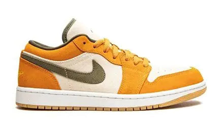 Orange sneaker with white and green accents on a white background