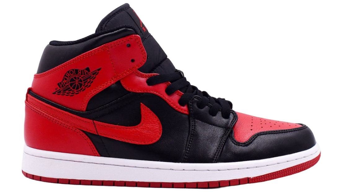 Black and red sneaker with a prominent Nike logo on a white background