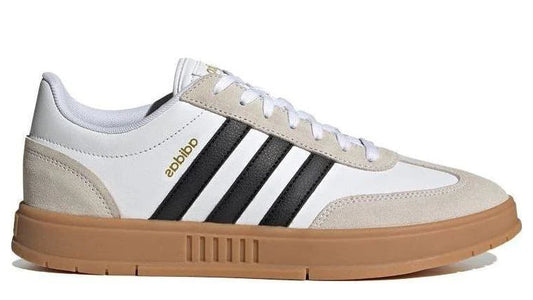 Beige and white Adidas sneaker with black stripes on a white background